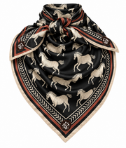 Horse Girl scarf in black with cream horses and a rust border, tied