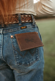 The Giano leather wallet in the back pocket of jeans