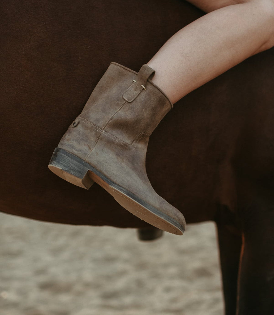 Rider on a horse wearing The Claudia short suede boot